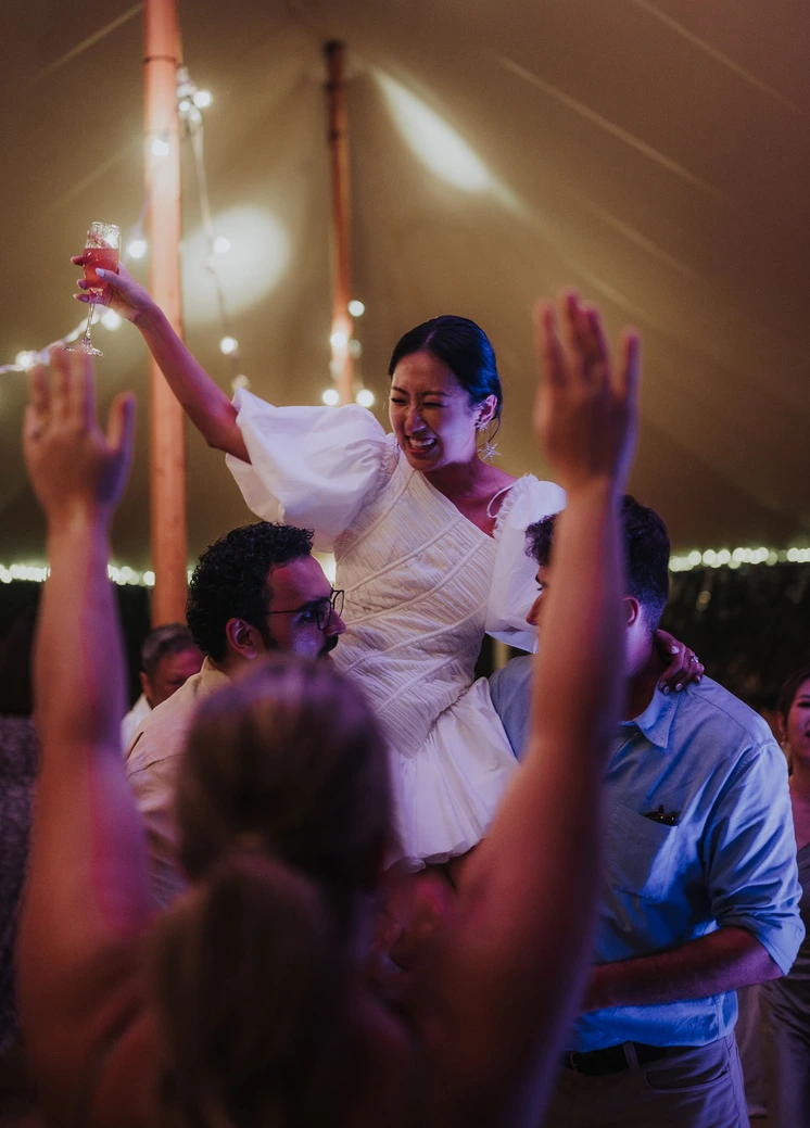 Bride being lifted at reception
